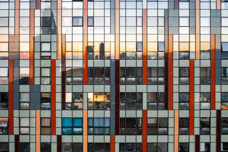 Mirror skyscraper wall background. Glass windows of temporary building.の写真素材