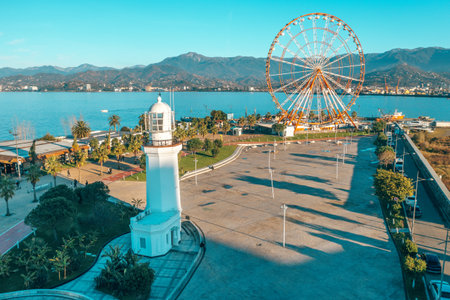 Aerial Drone view of Batumi embankment with lighthouse and Ferris wheel. Famous Georgian resort city.の写真素材