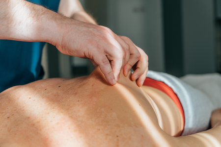 Massage therapist gives massage to patient, close-up. Wellness and revitalization massage and spa treatments.の写真素材
