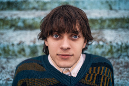 Close-up of man with deep blue eyes and curious gaze.
