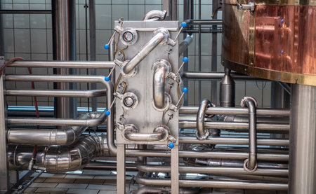 Close-up of stainless steel pipes and valves in a craft brewery.の写真素材