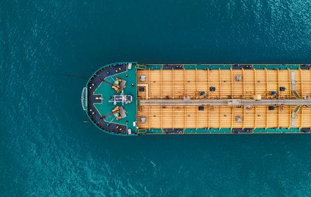 Detailed overhead perspective of oil tanker deck featuring robust piping, cargo compartments, and operational machinery for global energy transport.の写真素材