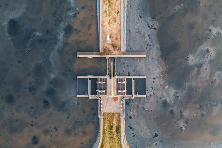 Wastewater treatment plant with sedimentation ponds aerial top view, filtration systems, industrial water management infrastructure. Environmental technology for sewage purification and sustainabilityの写真素材