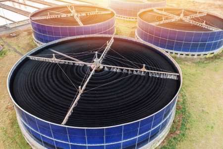 Aerial view large circular biofilter tanks at wastewater treatment plant. Industrial facility using biological filtration to purify sewage and protect environment.の写真素材