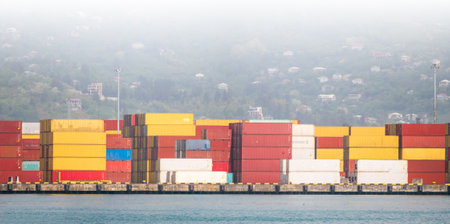Stacked cargo containers at logistics hub symbolizing export operations, distribution networks,...