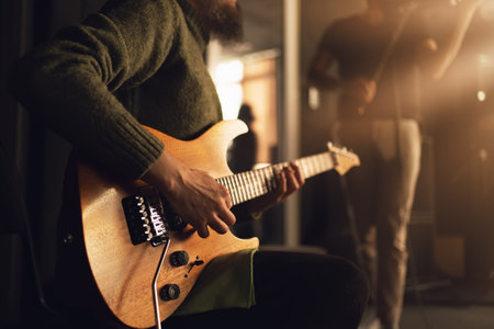 Guitarist play electric guitar, close up on hands. Music creativity, performance energy, indie rock atmosphere, teamwork.の写真素材