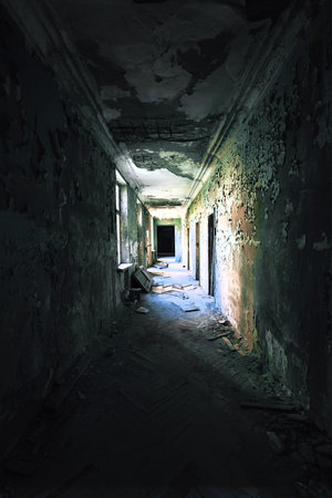 Dark abandoned hallway peeling paint and debris, spooky atmosphere, horror vibe, post-apocalyptic concept, mystery location, haunted building, vertical imageの写真素材