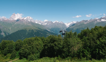 Mountain landscape with cable car gondola, scenic alpine view, hiking tourism, eco travel destination, snow peaks.の写真素材
