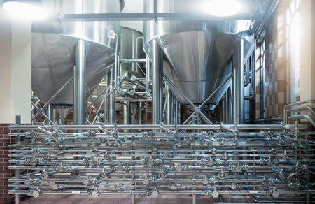 Fermentation tanks and complex pipeline system in modern beer brewery for industrial beverage...