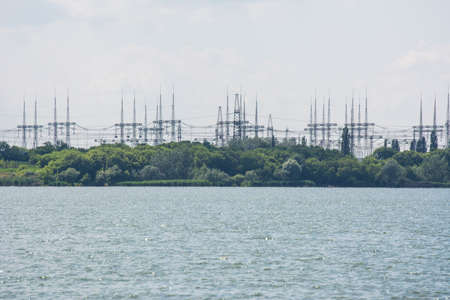 power lines of a nuclear power plant on the lake shore