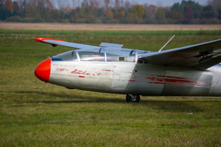 old glider on the grass of the runway USSR Red noseの写真素材