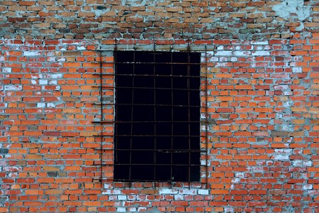 An old wall made from bricks with a windowの写真素材