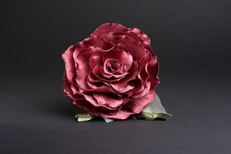 Artificial red rose at dark backgroundの写真素材