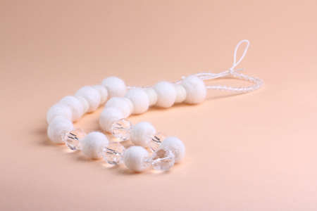 White beautiful beads at pink backgroundの写真素材