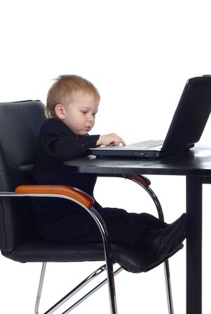 Little businessman working with computerの写真素材