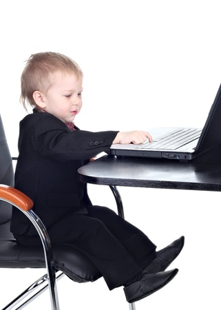 Little businessman working with computerの写真素材