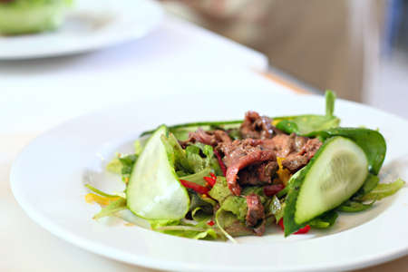 Salad with a beef on the tableの写真素材