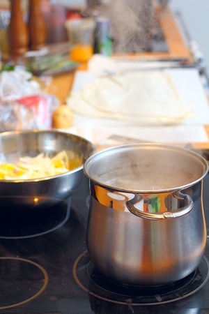 Stell saucepan with soup at the kitchenの写真素材