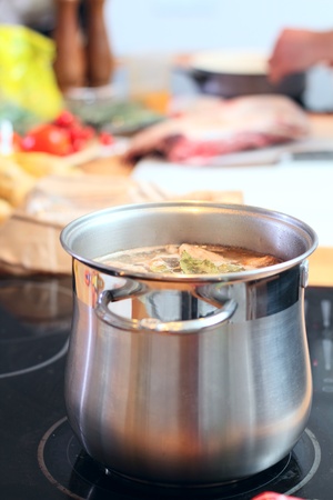 Stell saucepan with soup at the kitchenの写真素材