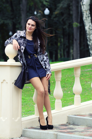 Portrait of young beautiful girl in the city parkの写真素材