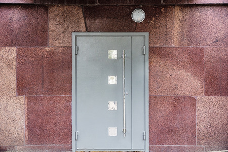 Metallic door at the marble wallの写真素材