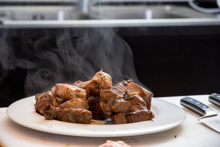 Fried meat slices on the plate on the kitchenの写真素材