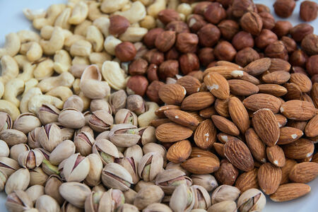 A lot of different nuts on the tableの写真素材