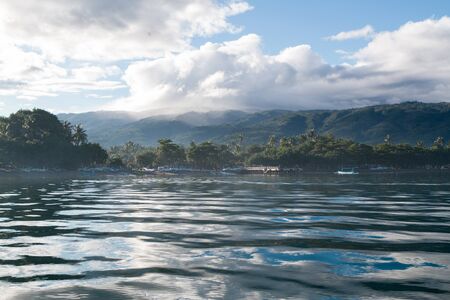 Ocean and boats moored in the morning. Calm surface of water