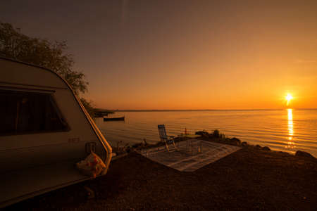 Sunrise at the lake, near caravanのeditorial素材