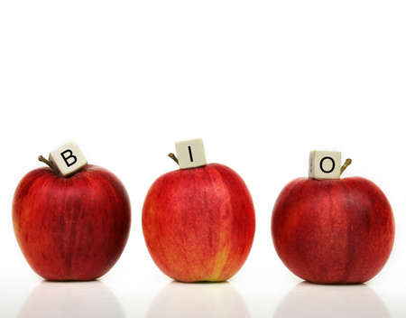 a row of six red apples with cubes of letters on it in front of a white background - bioの写真素材