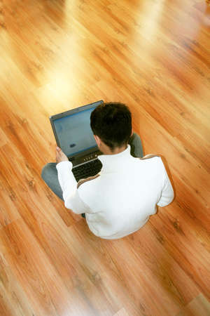 a young business man is holding a notebook in his hands in front of a shiny backgroundの写真素材