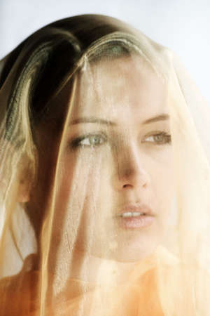 beauty portrait of a young beautiful woman with a shawlの写真素材