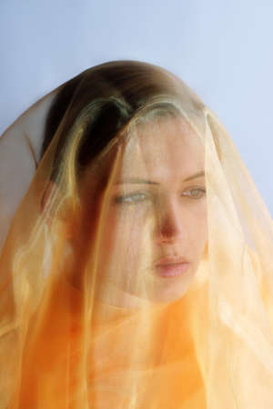 beauty portrait of a young beautiful woman with a shawlの写真素材