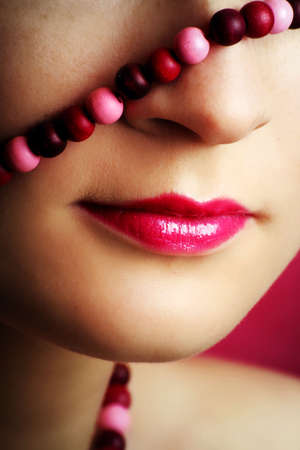 beauty portrait of a young woman in pink with a chainの写真素材