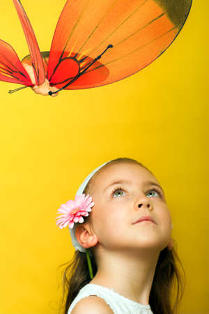 portrait of smiling girl with a red butterflyの写真素材