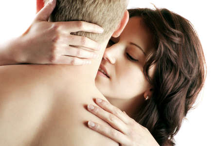 a young sexy couple is kissing isolated on white background