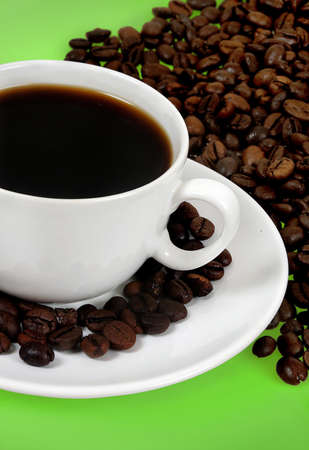 Cup of coffee on green background の写真素材