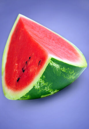One piece of watermelon on blue backgroundの写真素材