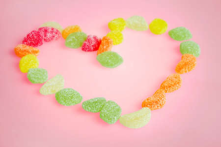 Love candies on pink backgroundの写真素材