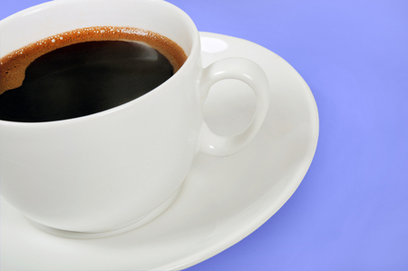 Cup of coffee on blue background の写真素材