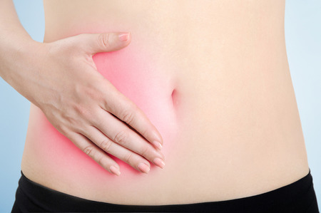 Hand on belly of blue background