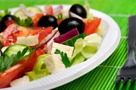 Plate with salad on green tableの写真素材