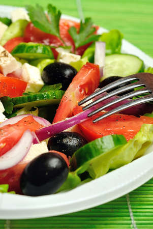 Plate with salad on green tableの写真素材