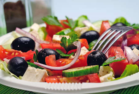 Plate with salad on green tableの写真素材