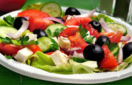 Plate with salad on green tableの写真素材