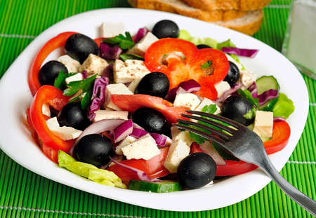 Plate with salad on green tableの写真素材