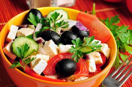 Bowl with salad on red tableの写真素材