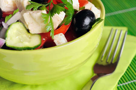 Bowl with salad on green tableの写真素材