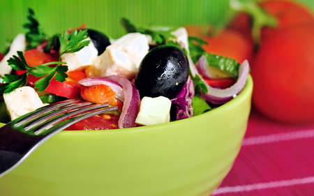 Bowl with salad on pink tableの写真素材