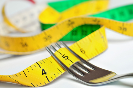 Fork with centimeter on tableの写真素材